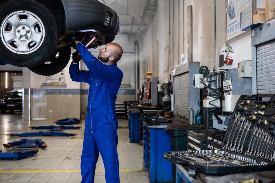 Mechanic performing a multi-point car inspection