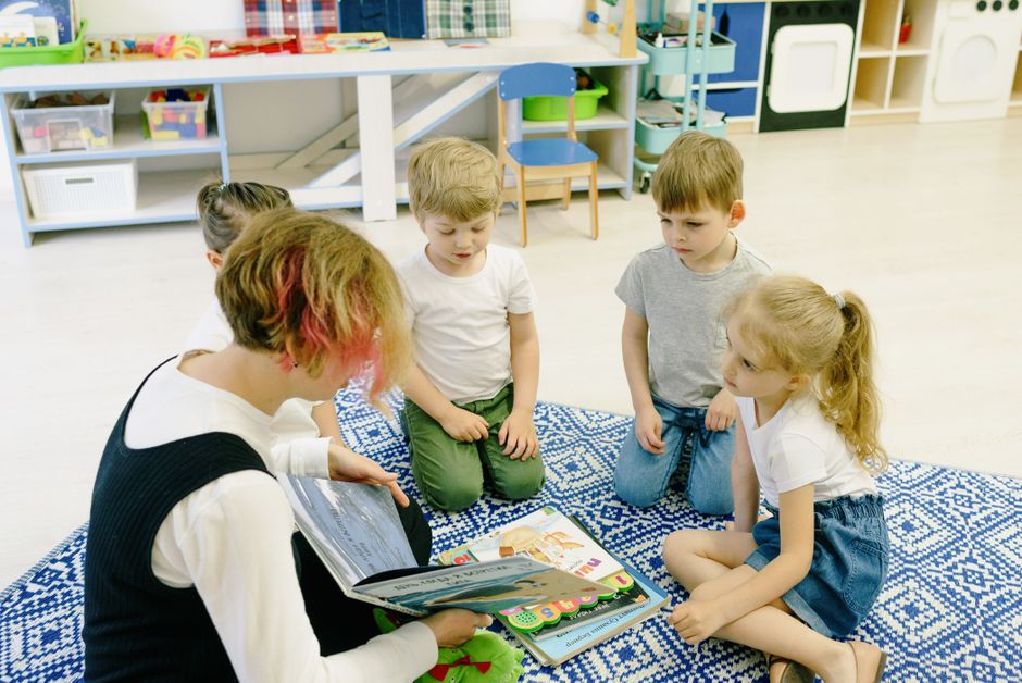 Educator engaging with children at an educational event hosted by a nonprofit.