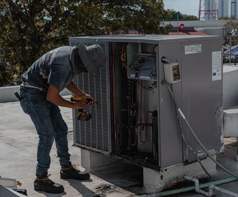 Blair Heating & Air technician with residential HVAC equipment