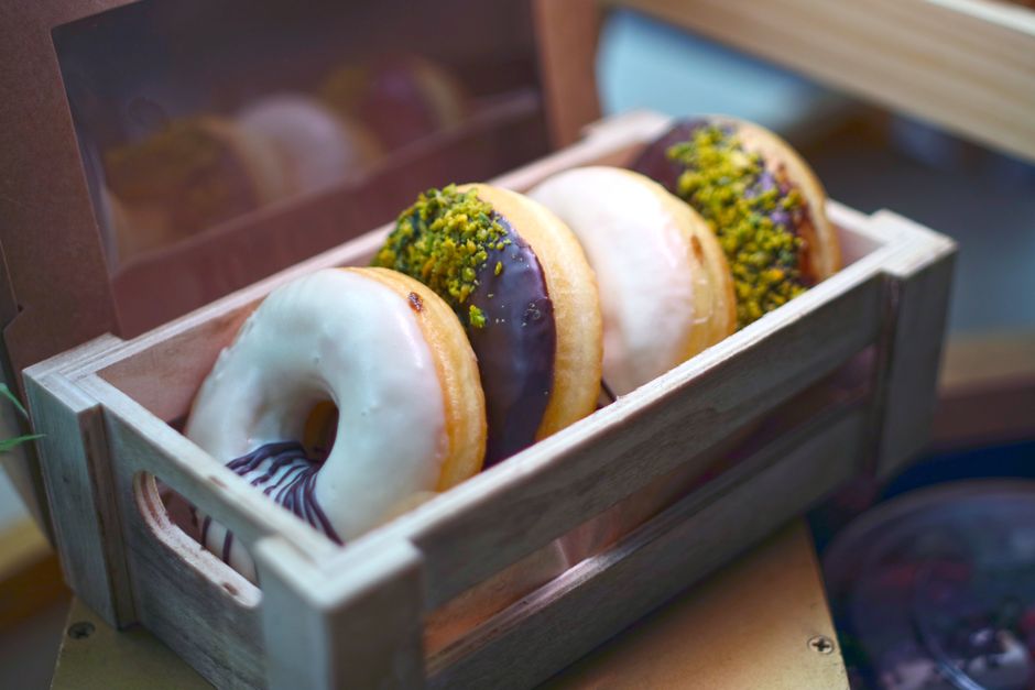 Assorted freshly baked donuts with glaze and toppings