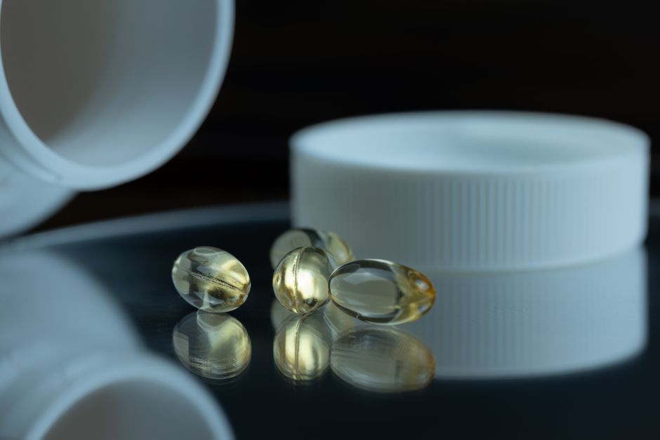Assorted dietary supplement capsules and bottles on laboratory table