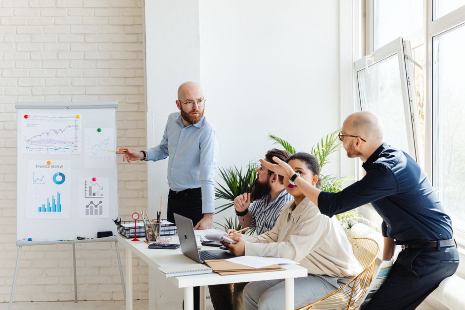 Consultants discussing enterprise IT architecture on a whiteboard