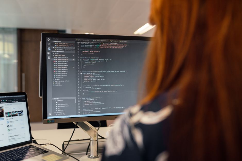 A software developer working on code at a computer screen