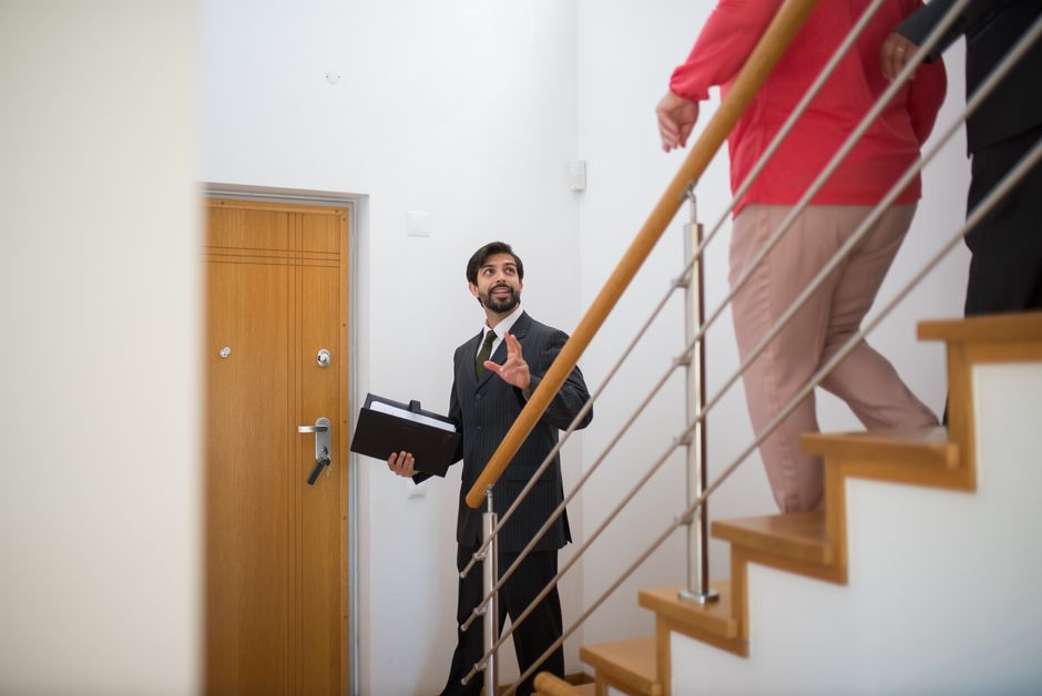 Family looking at house with real estate agent