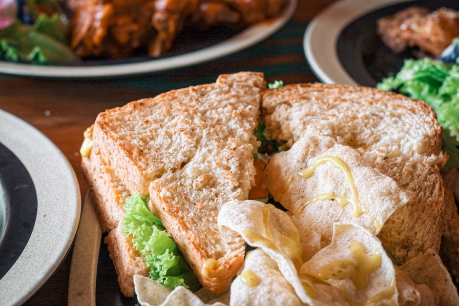 Breakfast sandwich and assorted savory snacks on a plate