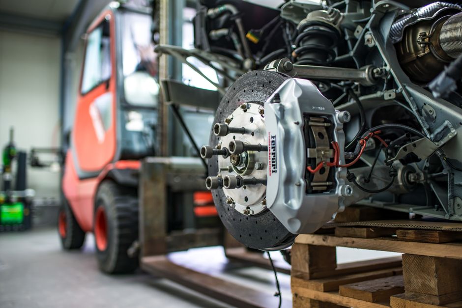 Close-up view of a car's brake and suspension components during maintenance