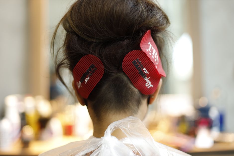 Woman receiving a professional hair styling in a salon setting