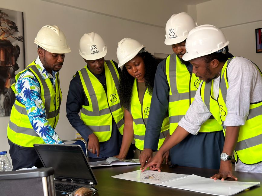 Team of geotechnical engineers reviewing site plans in an office