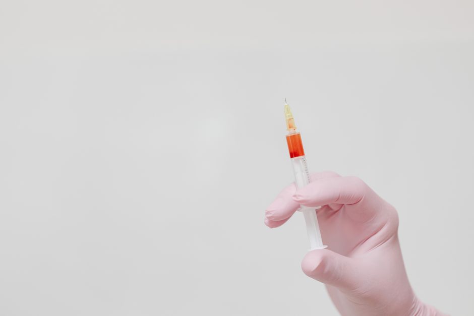 Pharmacist administering a flu vaccination to a patient