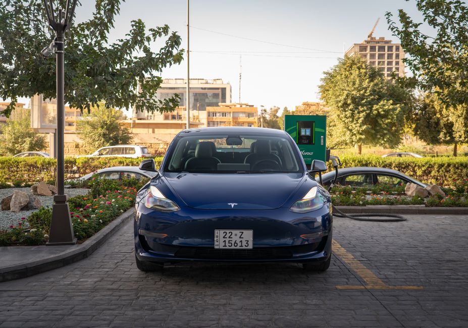 Close-up image of a Tesla Model 3 and charging station