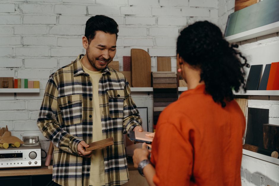 Business professionals discussing product samples at a table