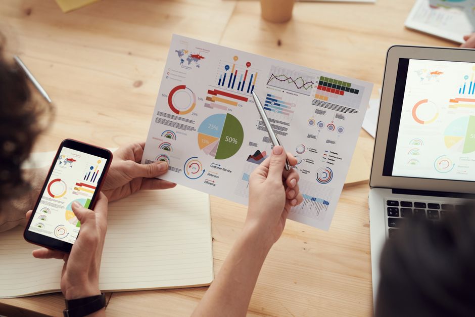 Team analyzing data and analytics on a digital dashboard