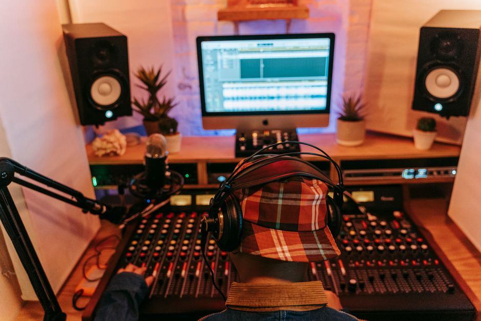Music producer working at mixing console in a professional recording studio