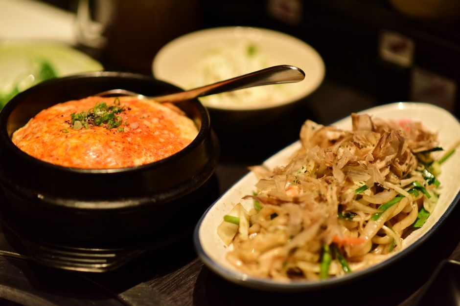 Asian rice and noodle side dishes served with dumplings.