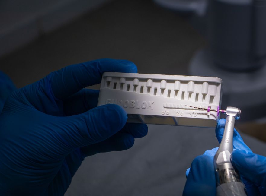 Dental professional holding a universal surgical guide in the clinic