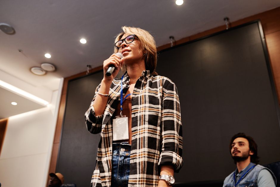 A female speaker delivering an inspirational talk to an audience