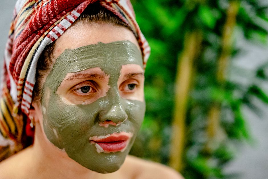 A client receiving a body wrap treatment in a beauty spa setting.