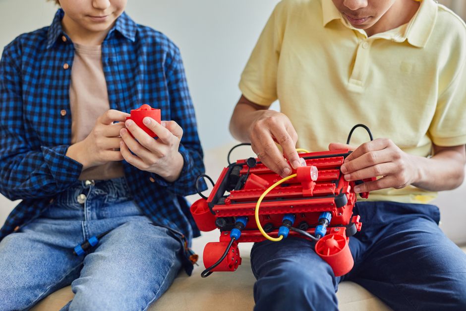 Youth assembling robots and working with electronics in a STEM camp