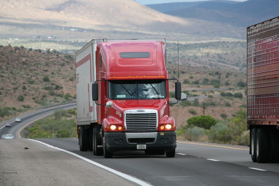 Modern freight trucks transporting cargo across interstate highways