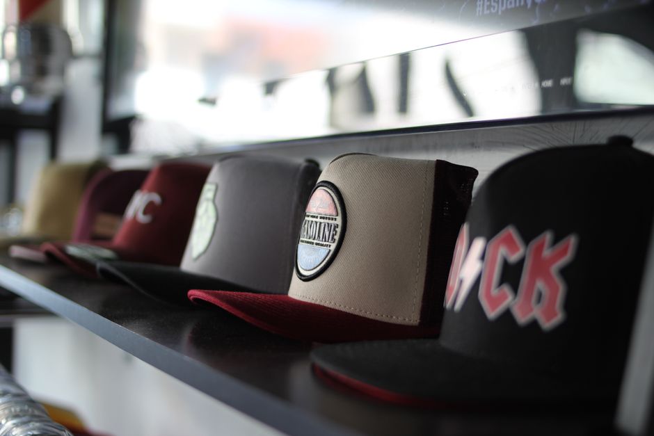 Baseball caps, winter gloves and hats on store shelf