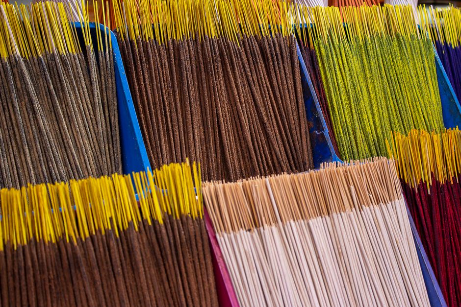 Selection of incense sticks and aromatic candles arranged for sale.