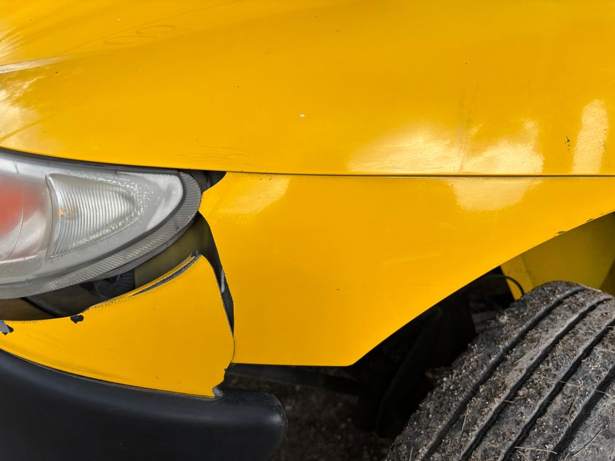 Auto body shop exterior with vehicles being repaired