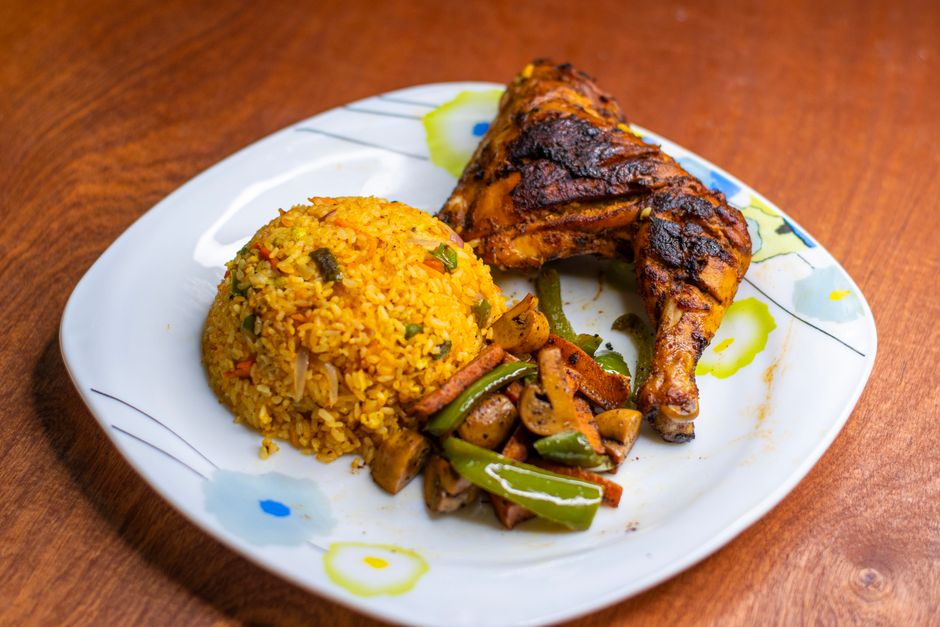 Jollof Rice in a traditional setting with West African side dishes
