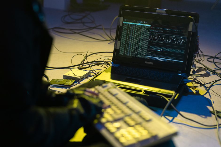 Cybersecurity expert monitoring network systems for breaches