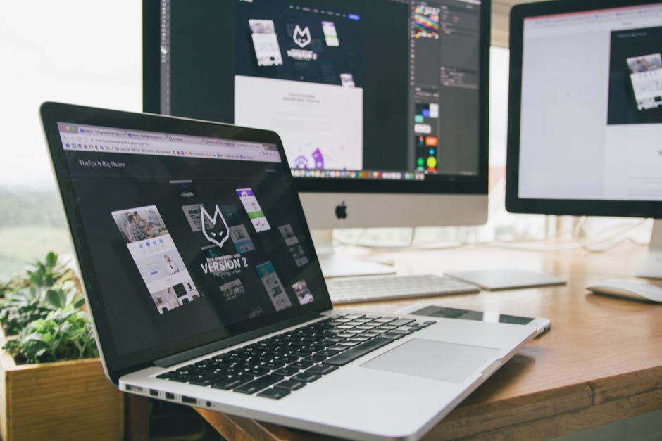 Apple Mac workspace with software design on screen