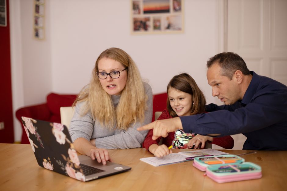 Parents and children exploring educational resources together