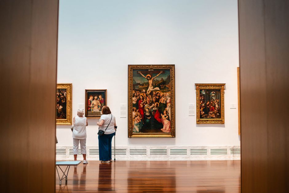 Visitors viewing exhibits in a bright, spacious gallery interior