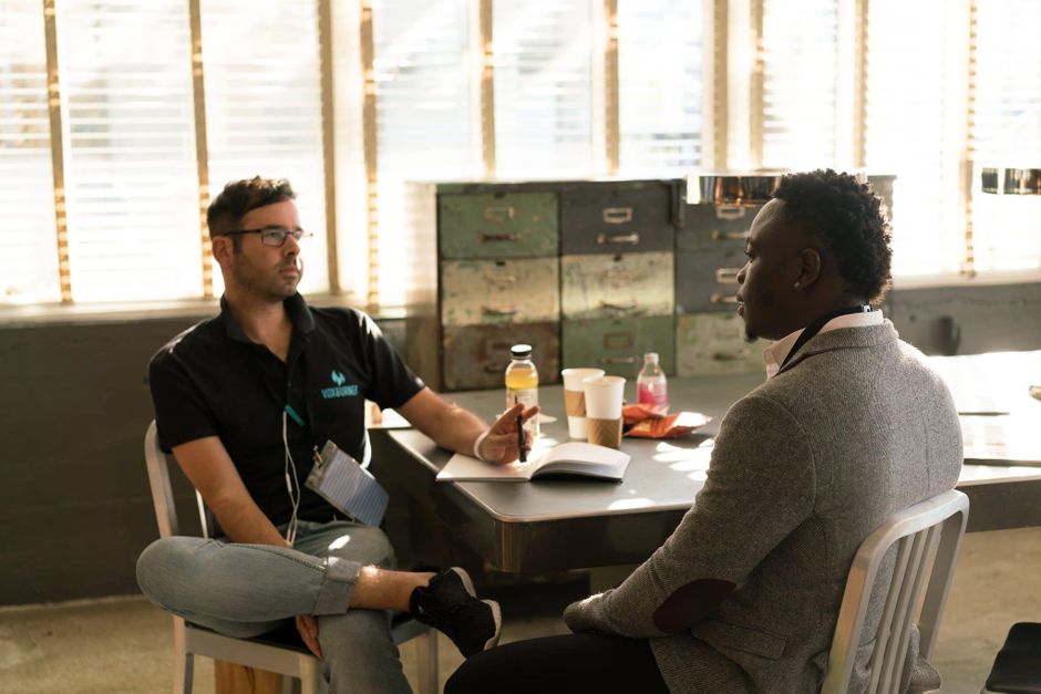 Two adults discuss sleep health resources in a comfortable office