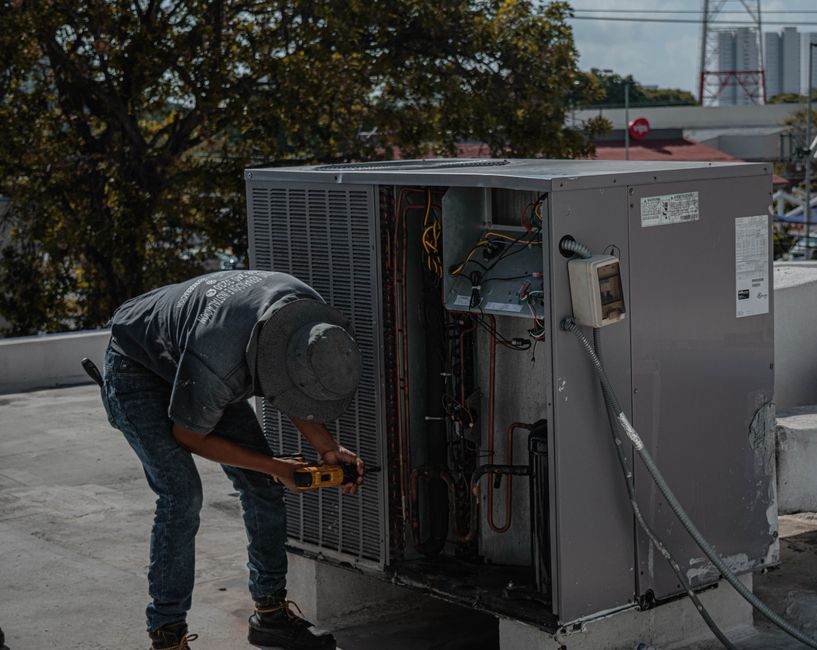 Technician installing an air conditioning unit