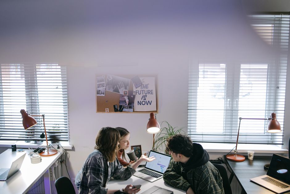 Colleagues discussing cloud implementation strategies in a modern office