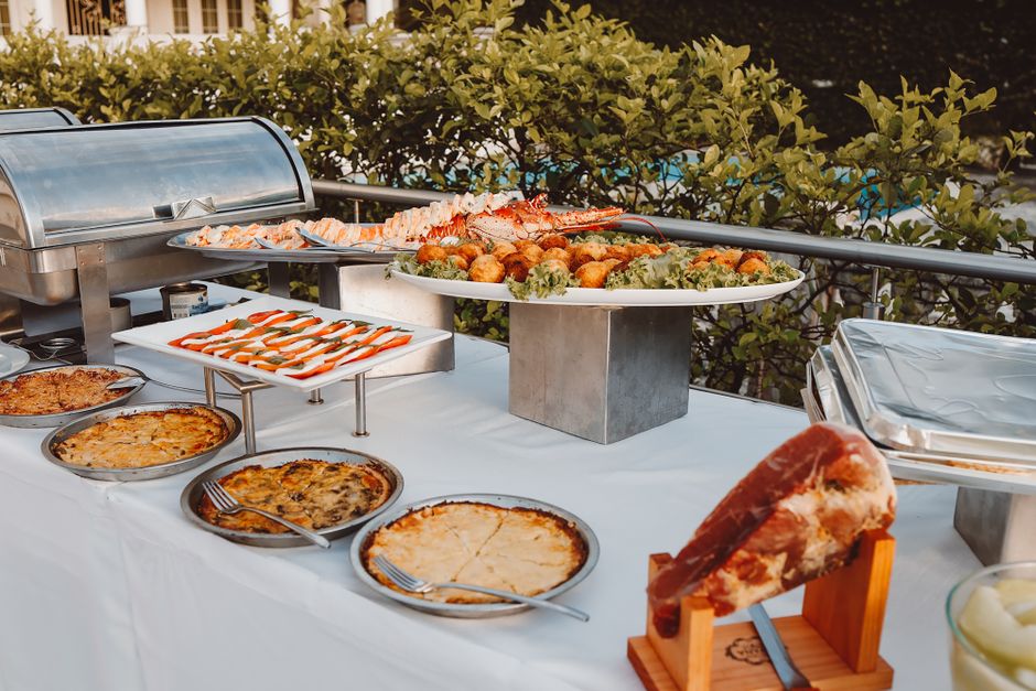 A beautifully arranged catering table featuring fresh seafood and ceviche dishes