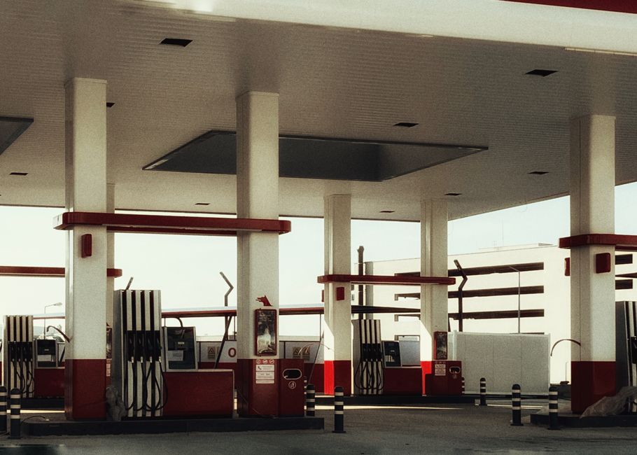Fuel pumps at a gas station with an attendant nearby