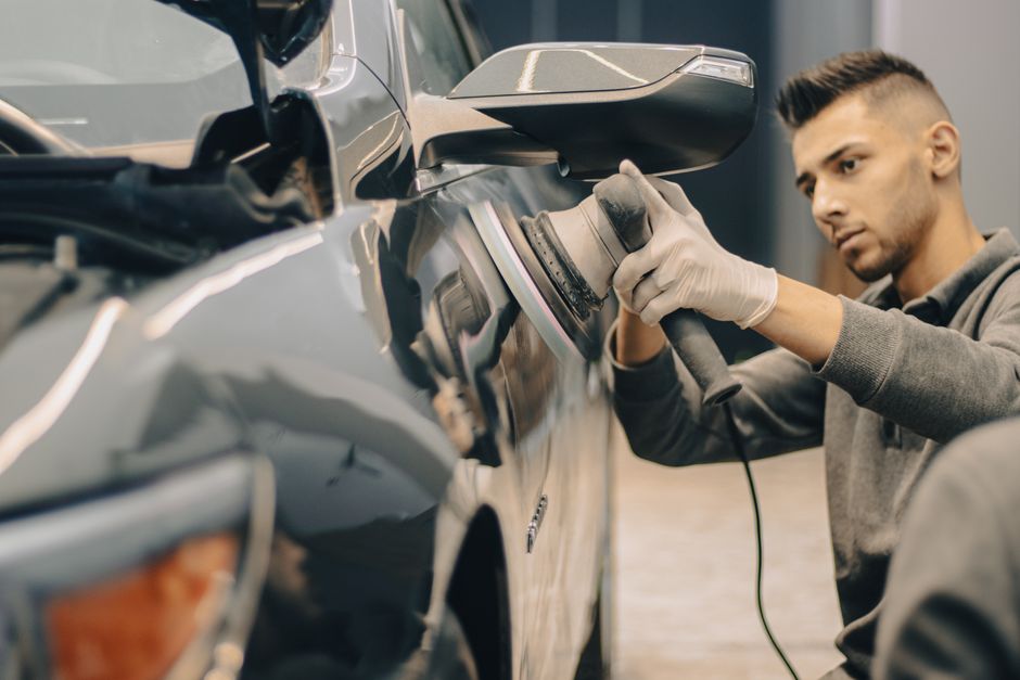 Bodywork technician working on a vehicle panel