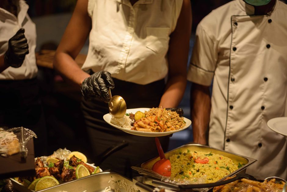 Catering staff serving creative gourmet food