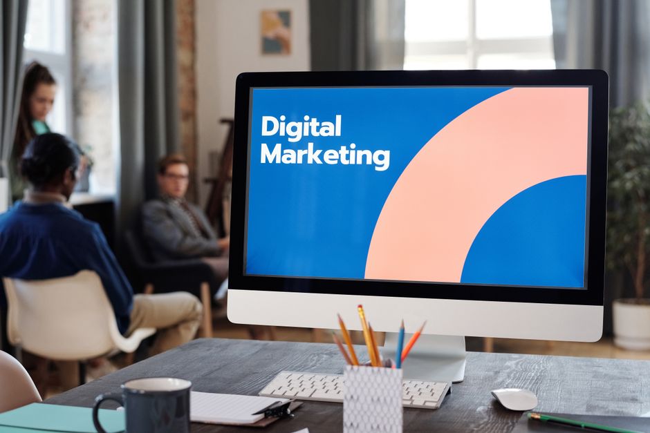 Creative team strategizing a digital marketing campaign around a table