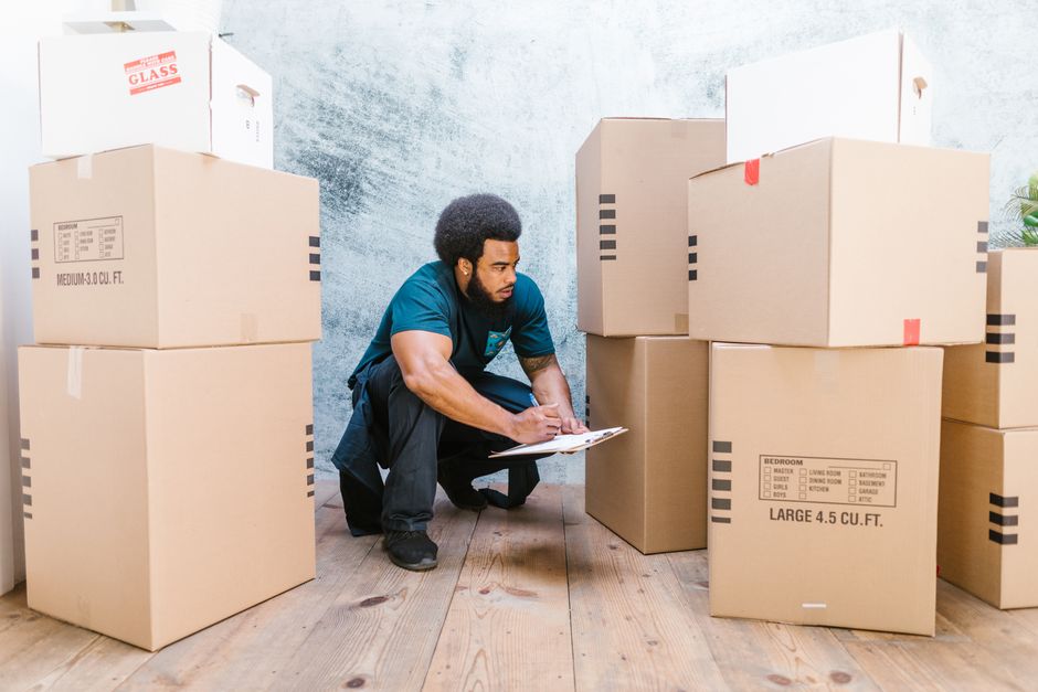 Movers packing household items for a residential relocation