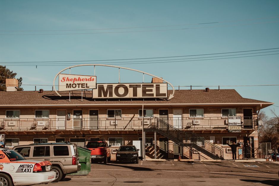 Motel exterior near San Jose airport in daylight, with parking