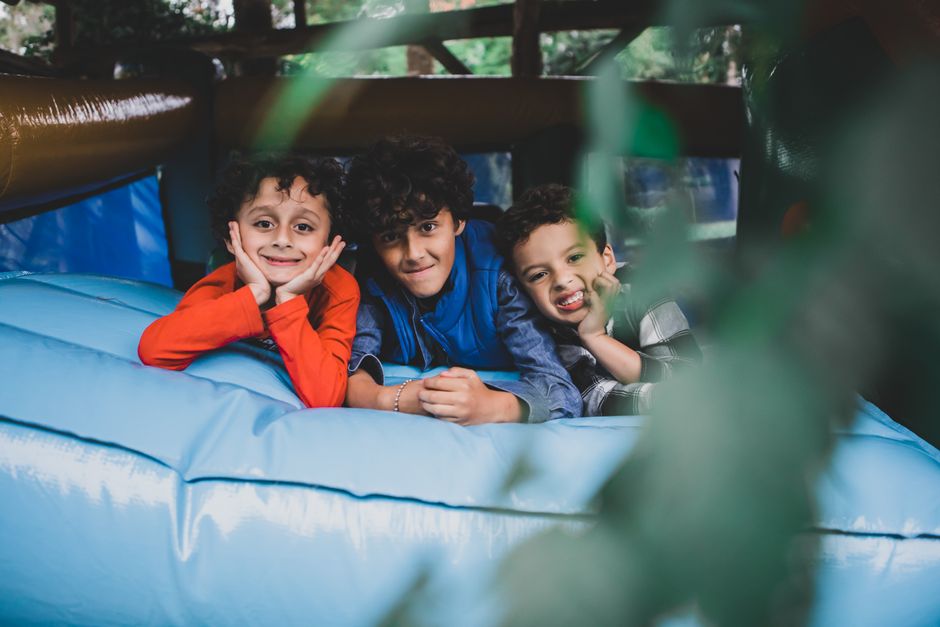 Children playing on indoor trampolines and inflatable castle