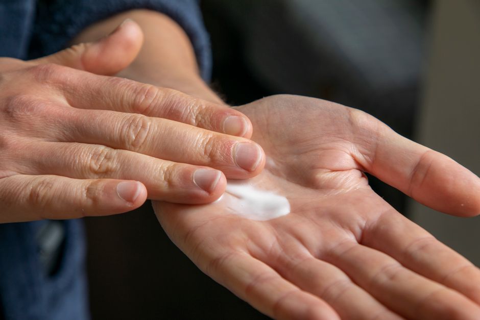 Hands applying nourishing skincare
