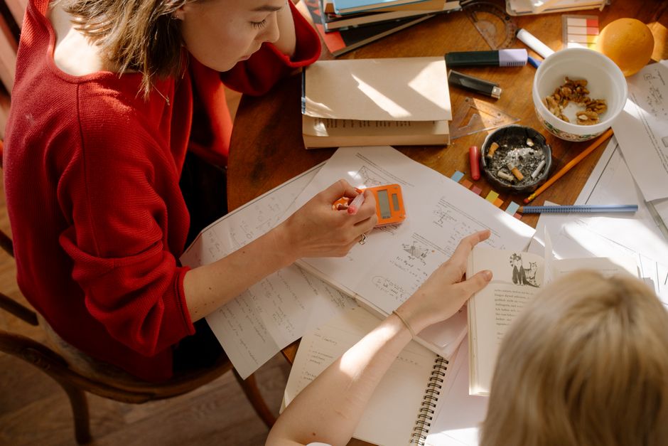 High school students preparing for AP Physics exam with study materials