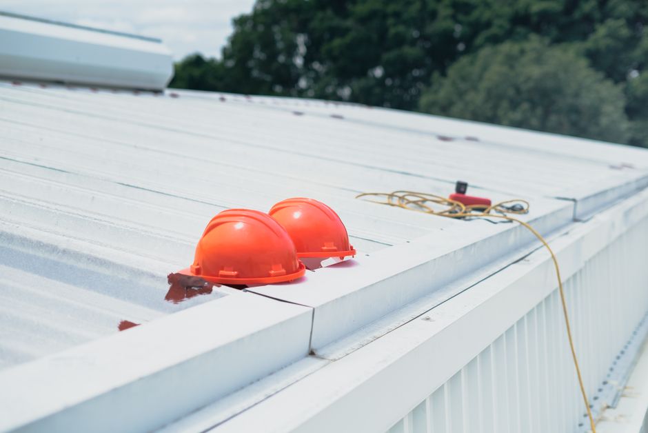Inspector documenting a commercial roof during maintenance