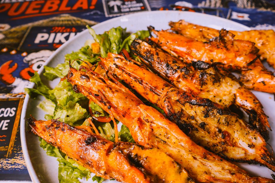 An assortment of colorful Mexican coastal cuisine including tacos and seafood