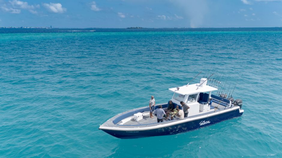 People fishing together on a deep sea boat
