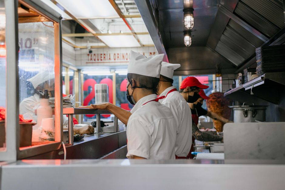 Staff preparing food in a professional kitchen