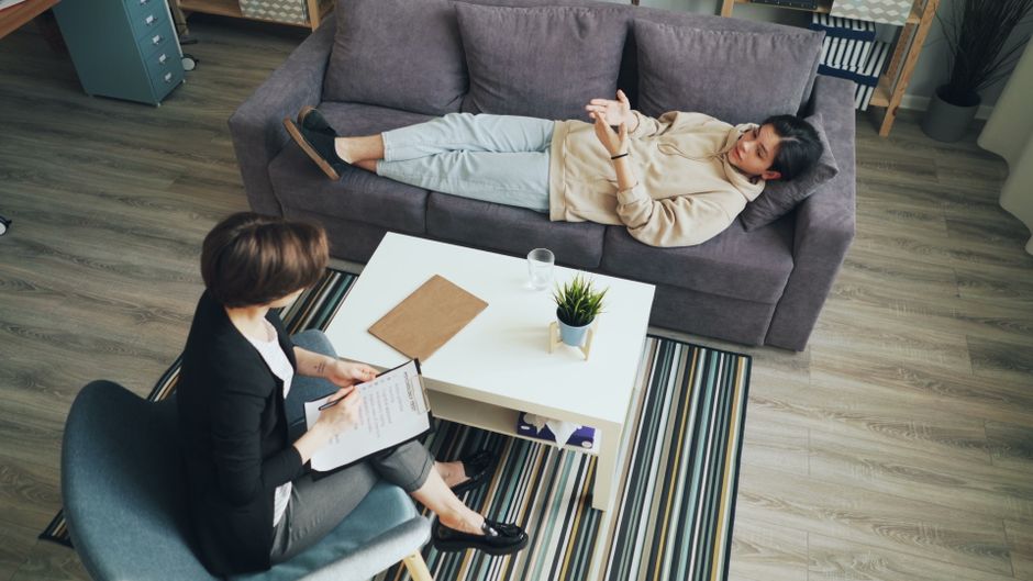 Woman processing trauma with psychologist