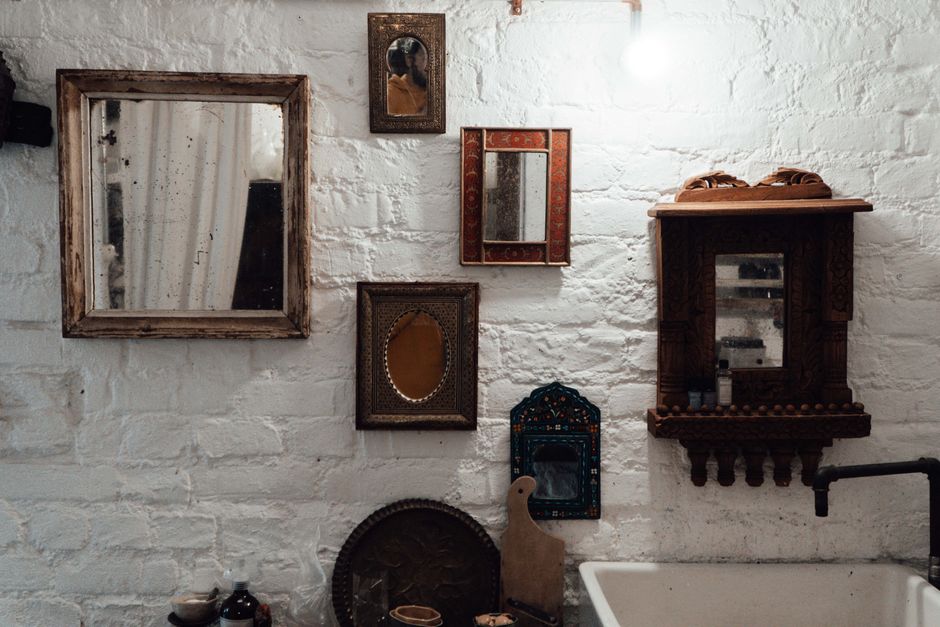 Decorative wall mirror set in a bespoke crafted frame.